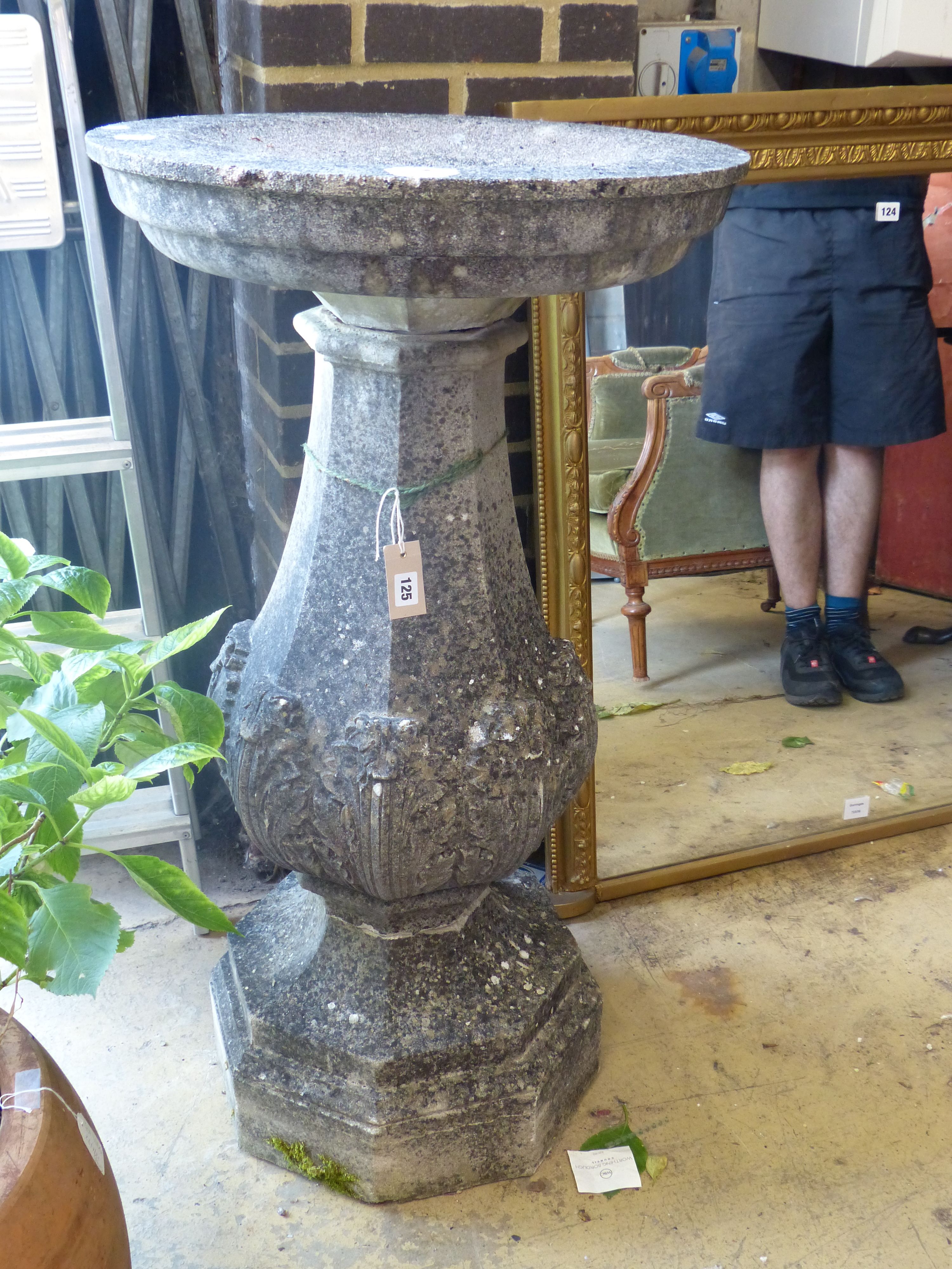 A reconstituted stone bird bath